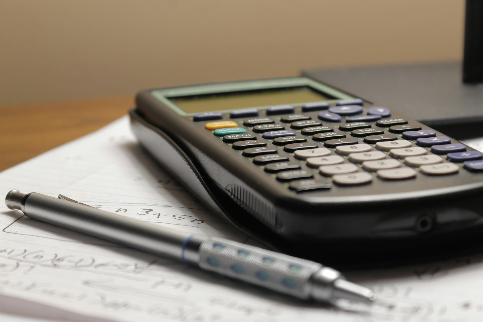 A calculator and pen on scoping notes, working out what drives the cost of a VAPT
